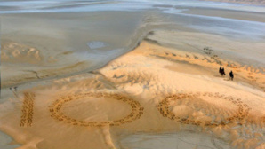 Giant 2.3m by 2.5m horse hoof prints created in the Bay of Mont-Saint-Michel, the famous UNESCO World Heritage Site, by French artist and sand sculptor Christophe Dumont. Photo (c) Dan Towers / FEI